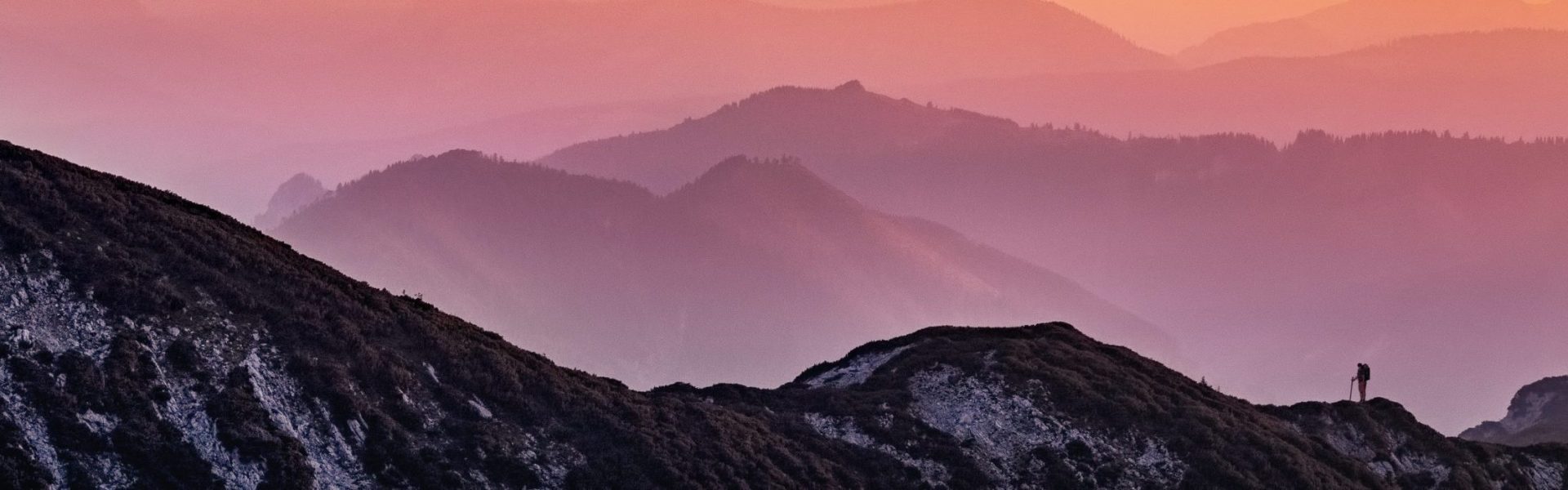 rainbow colored sunset over misty mountains